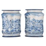 A pair of blue and white decorated stoneware albarelli, the body depicting pastoral scenes and with
