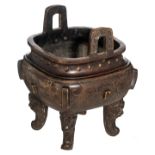 A Chinese archaic-style patinated quadrangular bronze incense burner, the legs mythical head-shaped,