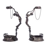 A pair of 925/000 silver wine bottle holders, both shaped as nymphs holding the bottleneck, probably