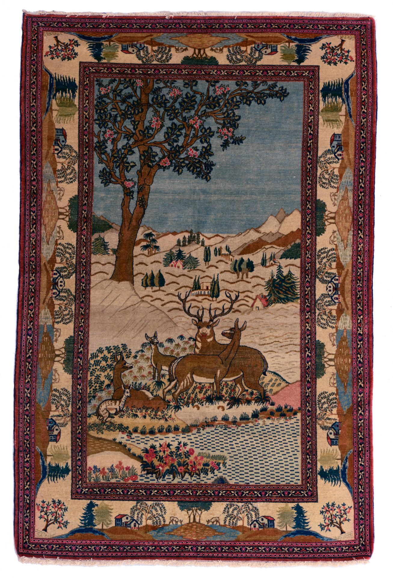 An Oriental Kashan rug, decorated with deer in a landscape, 138 x 210 cm