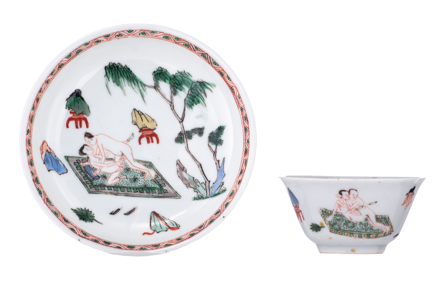 A Chinese famille verte cup and saucer, decorated with an erotic scene, Kangxi symbol mark and of th - Image 2 of 7