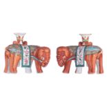 A pair of Chinese red-coral ground and famille rose elephant-shaped joss stick holders, first half o