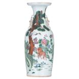A Chinese polychrome vase, decorated with deer and a crane among rocks and flowers, the reverse with