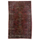 A large Oriental woollen rug, floral decorated, 306 x 511 cm