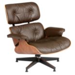 A rosewood and chocolate brown leather upholstered Eames lounge chair, design by Charles and Ray Eam