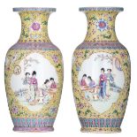 A pair of Chinese yellow ground famille rose floral decorated vases, the panels with female figures