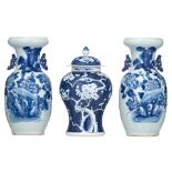 A pair of Chinese celadon ground blue and white floral decorated vases; added a ditto vase and cover