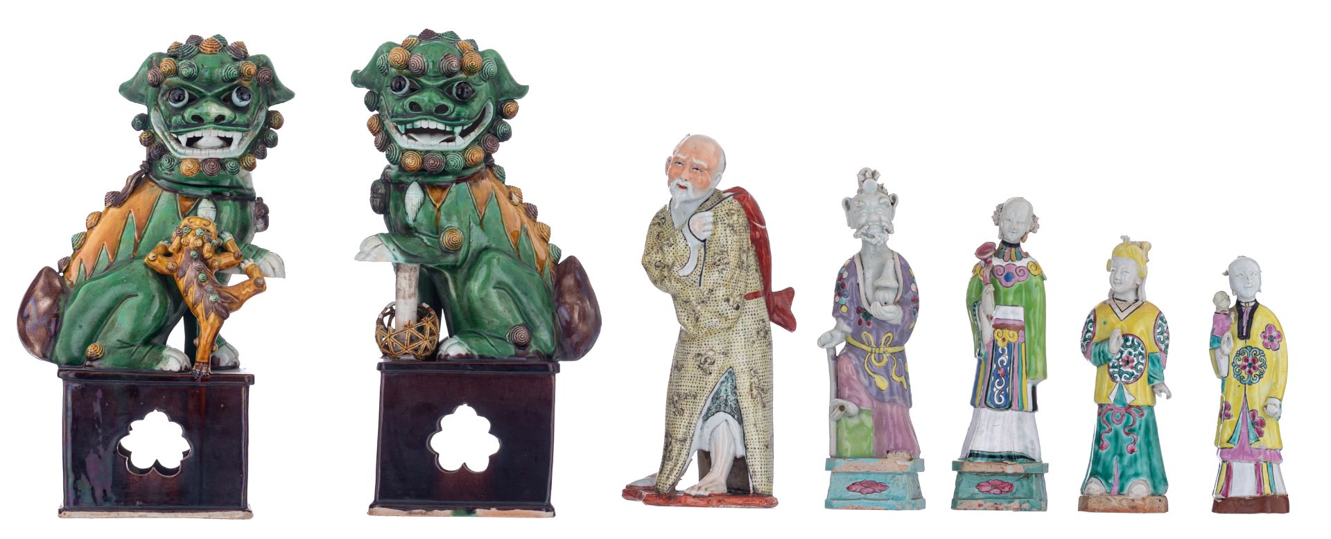 A pair of sancai Fu lions; added five polychrome decorated figures, depicting standing figures, i.e.