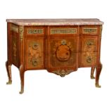 A fine walnut veneered French Transition style commode, decorated with marquetry in various wood spe