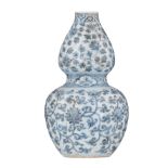 A Chinese Ming style blue and white double gourd vase, decorated with scrolling lotus, H 25 cm