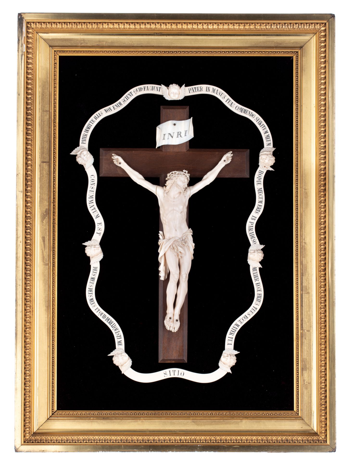 A finely sculpted ivory Corpus Christi on a walnut crucifix, surrounded by an ivory garland decorate