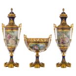 An imposing and exceptional Sèvres three-piece garniture set, consisting of two large bleu royale gr