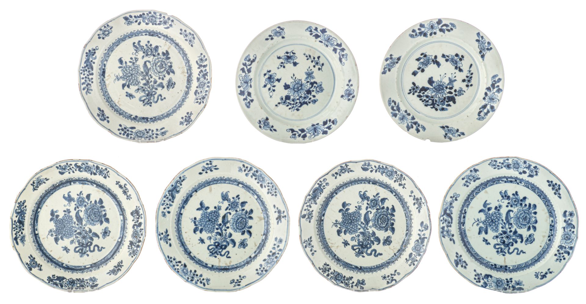 Five Chinese blue and white floral decorated dishes, the centre with butterflies; added two ditto di