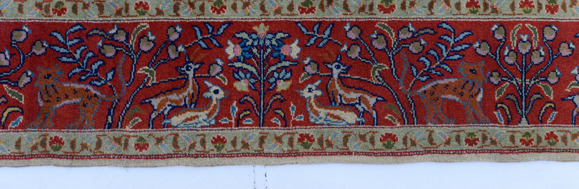 An Oriental woollen rug, decorated with hunting scènes to the center, and with animals and floral mo - Bild 5 aus 9