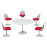 A dining set of a Tulip table and five Tulip chairs, design by Eero Saarinen for Knoll International