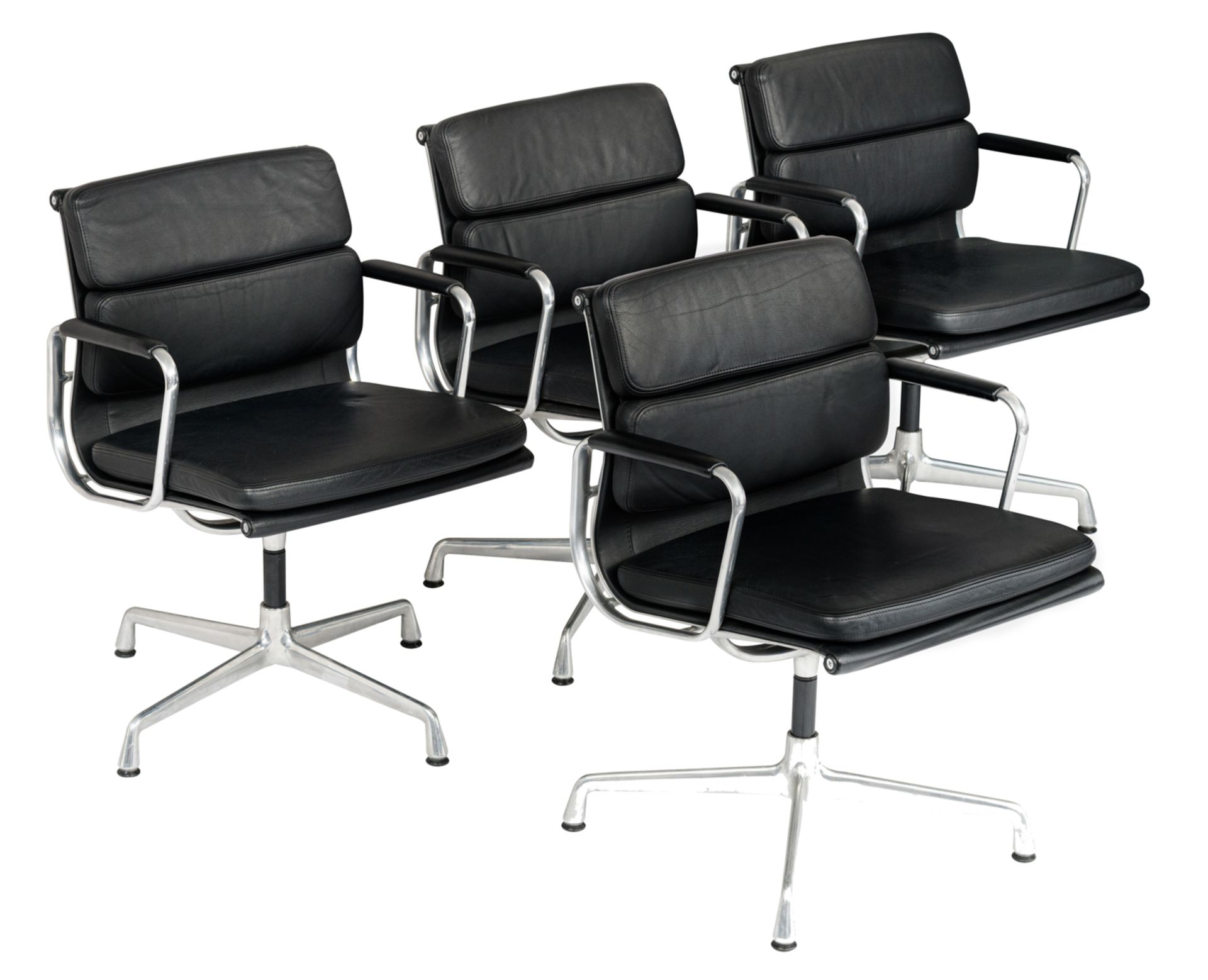 A set of four polished aluminium and black leather upholstered EA208 soft pad chairs, design by Char