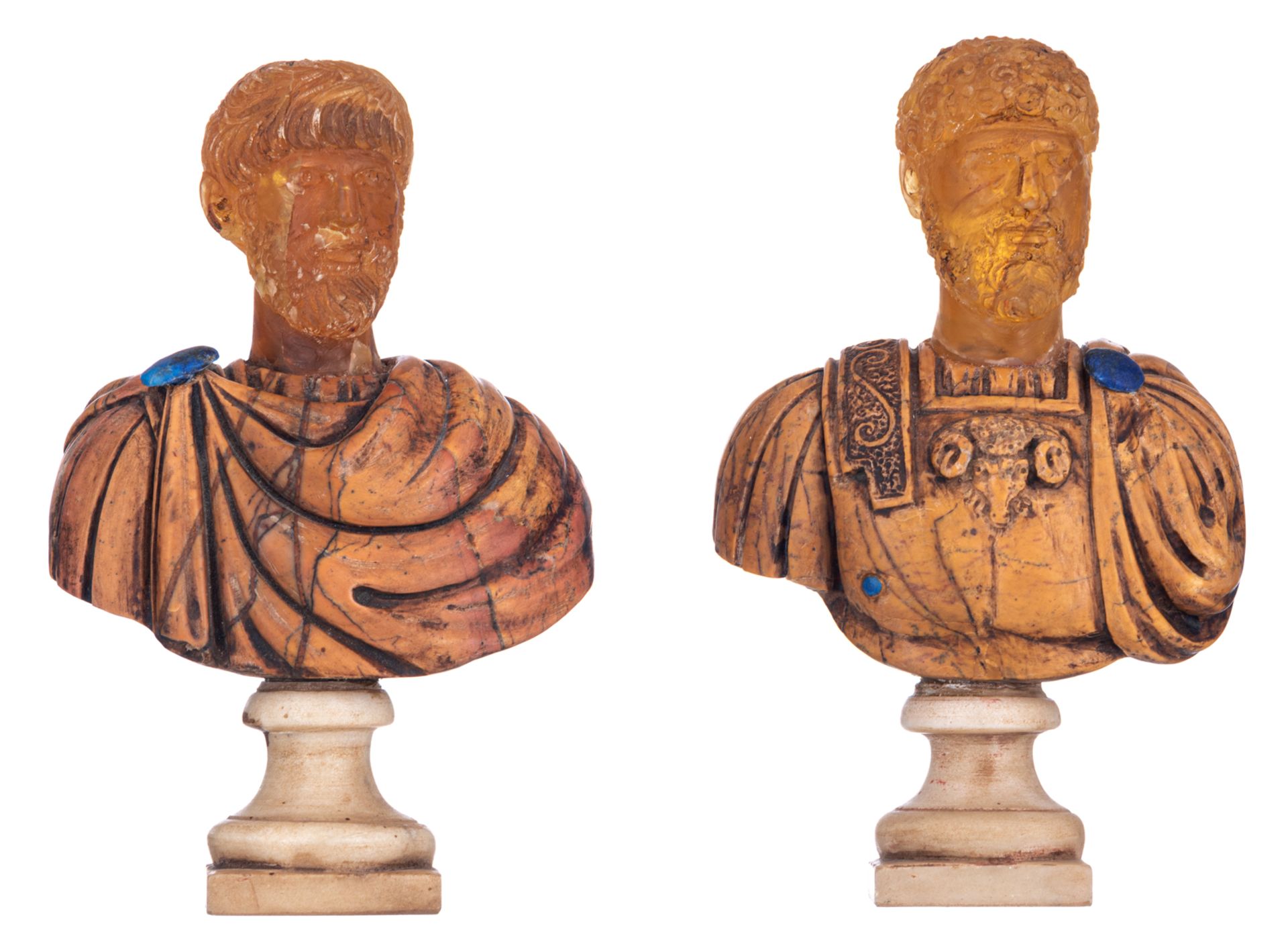 The portrait of Roman emperors after the antique, two decorative busts, amber stone on a marble base