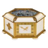 A combined hexagonal box containing a jewelry store-compartment, a table clock and a barometer, gilt