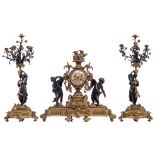 An imposing gilt and patinated bronze Neoclassical three-piece mantle clock garniture, the clock dec