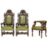 A pair of English Jacobean style abundantly carved walnut armchairs, the top ornament with two lions