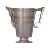 A circular Italian silver helmet ewer with an engraved body and an applied spout chased as a Neoclas