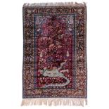 An Oriental silk rug, depicting various animals by a pond, signed by the artist, 135 x 197 cm