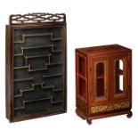 A Chinese richly carved gilt decorated elmwood display cabinet, on a ditto matching base; added a di