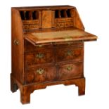 A fine walnut veneered George I fall front desk, the inside with a green leather writing surface and