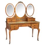 A Neoclassical mahogany veneered parquetry dressing table, with brass mounts and on top three oval-s