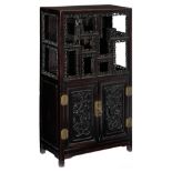 A Chinese exotic hardwood display cabinet, with richly carved open work bands and brass mounts, deco