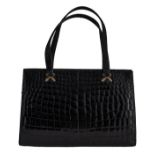 A Delvaux top handle handbag in black croco leather, H 18,5 x 28,5 cm