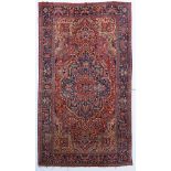 A large Herriz woollen rug, decorated with geometric motifs, 340 x 590 cm