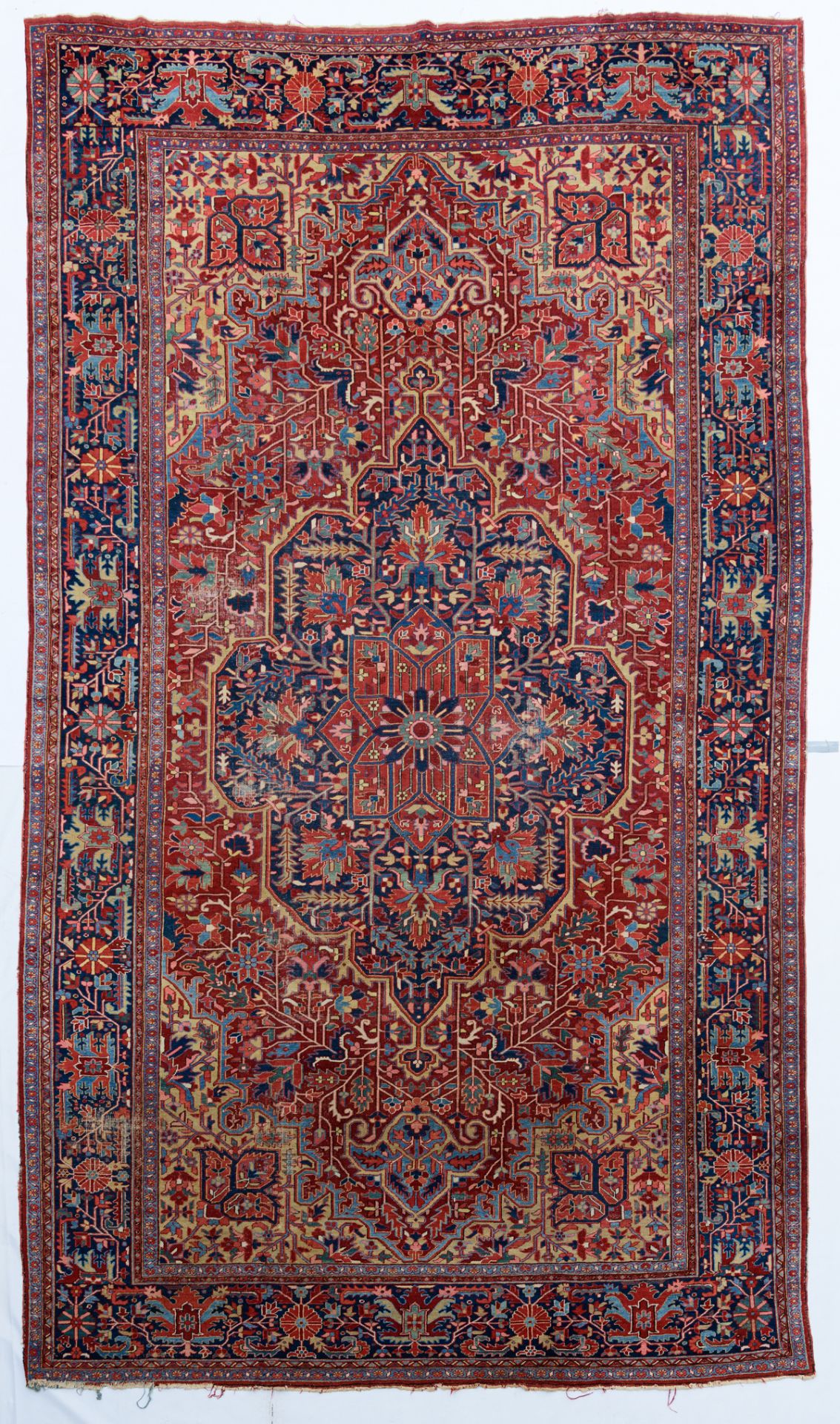 A large Herriz woollen rug, decorated with geometric motifs, 340 x 590 cm