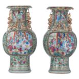 Two Chinese Canton relief decorated baluster-shaped vases, the panels with a court scene, paired wit