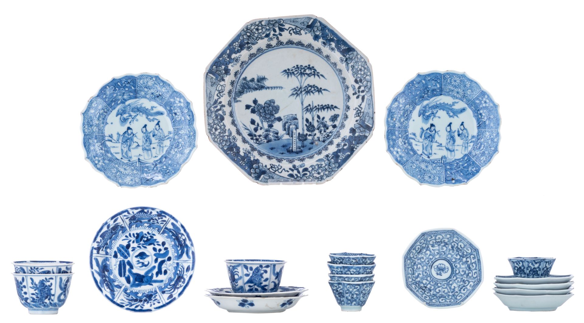 Three Chinese blue and white Kangxi period teacups and saucers, decorated with an underwater jungle;