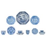 Three Chinese blue and white Kangxi period teacups and saucers, decorated with an underwater jungle;