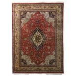 An Oriental woollen rug, floral decorated, 253 x 345 cm