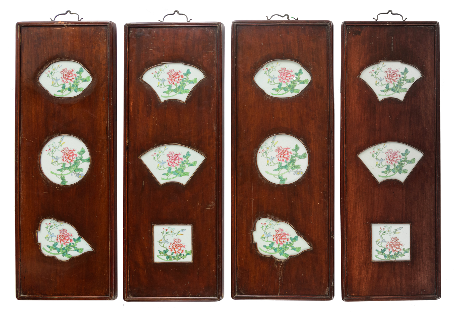 Four Chinese decorative exotic hardwood panels, the famille rose porcelain plaques decorated with fl