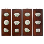 Four Chinese decorative exotic hardwood panels, the famille rose porcelain plaques decorated with fl