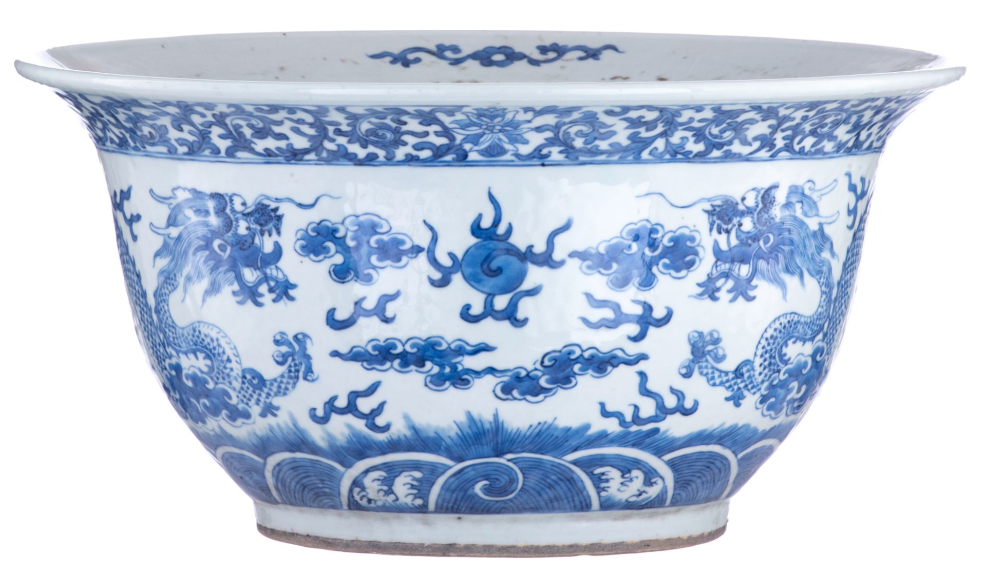 A Chinese blue and white jardinière, decorated with a pair of dragons chasing a flaming pearl amidst