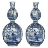 A pair of blue and white double gourd Dutch Delftware vases, the roundels with chinoiserie decoratio