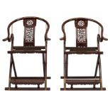 An imposing pair of Chinese exotic hardwood horseshoe-back 'Jiayi' armchairs, richly sculpted with o