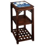 A Chinese quadrangular hardwood carved stand, the top with a blue and white porcelain plaque, decora