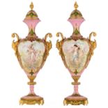 An exceptional pair of rose pompadour ground and gold-layer decorated vases, the roundels with hand-