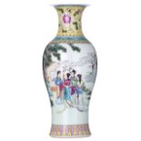 A Chinese polychrome vase, decorated with ladies in a garden setting, the back with calligraphic tex
