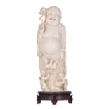 A Chinese Canton ivory statue depicting Budai accompanied by children, with engraved 'Ming dynasty'