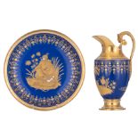 A fine cobalt blue ground porcelain pitcher and wash basin, finely decorated with Oriental figures,