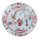 A Chinese famille rose plate, decorated with two Immortals, an attendant, and a flying phoenix in a