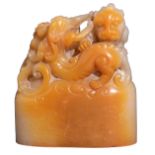 A Chinese russet jade seal, sculpted on top with playing chilong, H 7,3 - W 6,5 - D 3,2 cm