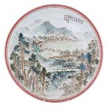 A Chinese yangcai plate, decorated with a village in a mountainous landscape, with a text signed 'Ch